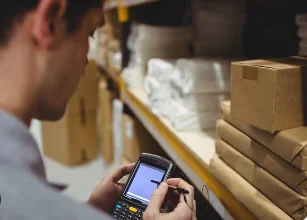 Someone doing a shelf stocktake with a handheld scanner